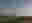 Snappy Valley - Group Therapy Image shows a person stood in a landscape of beautiful rolling hills. They are standing at the top of a hill, covered head to toe in tin foil, which reflects the sun. The valley opens up behind them.