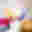 A blurred image of yellow, red, blues, purples and cream colours making an abstract shape